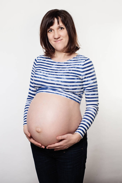 Happy Pregnant Woman on Grey Background - Fotografie, Obrázek