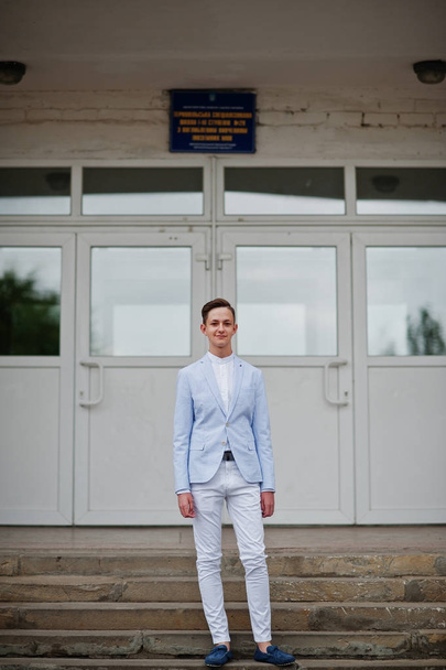 Portrait of a handsome high school graduate in stylish tuxedo po - Фото, изображение