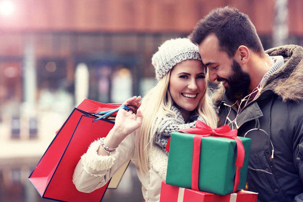 Picture of couple shopping for Christmas in the city - Photo, Image