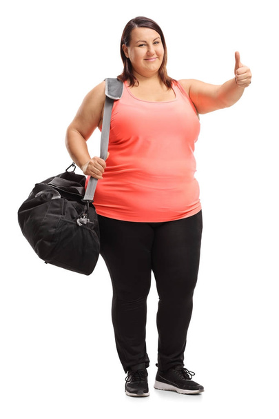 woman with a sports bag making a thumb up gesture - Foto, imagen
