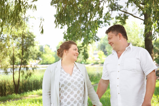 Overweight couple in park on sunny day - Fotografie, Obrázek