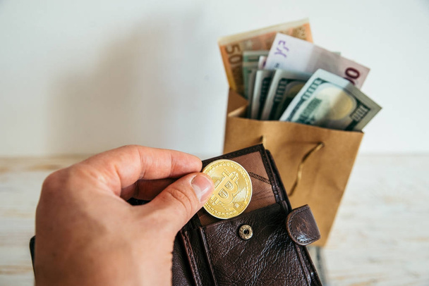 hand hold bitcoin money euro dollars in package - Фото, зображення