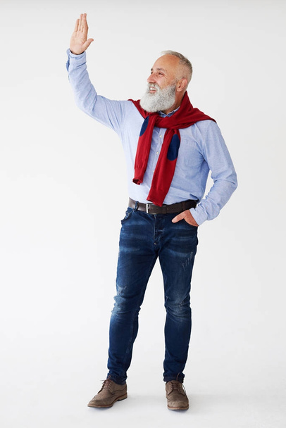 Smiling senior bearded man waving for someone on sideway   - Photo, Image