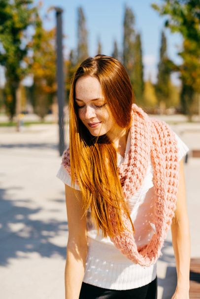 girl with red hair walks in the autumn park - Photo, image