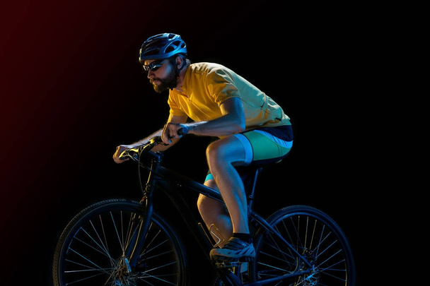 The bicyclist on black, studio shot. - Photo, image