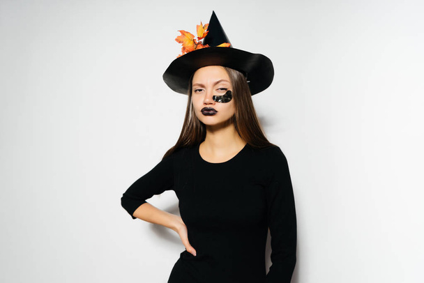 girl in a witch suit on a white background - Fotoğraf, Görsel