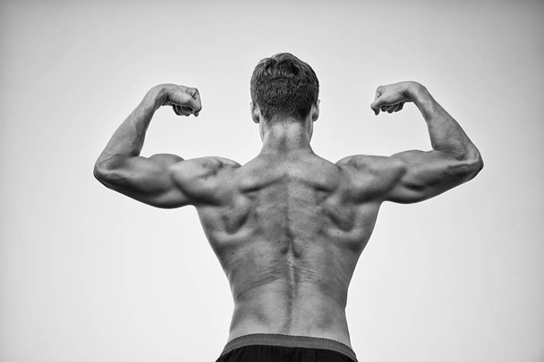 Bodybuilder showing muscles, biceps and triceps - Фото, зображення