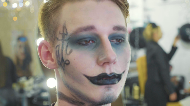 Artista applicando trucco Halloween su modelli maschili viso
. - Filmati, video