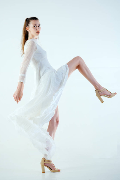 Girl in white fashionable dress. - Foto, afbeelding