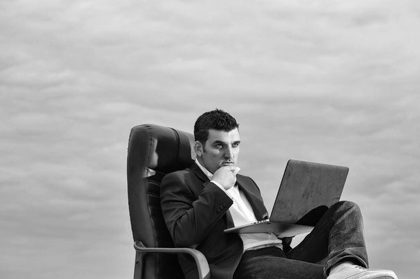 businessman with laptop on chair outdoor - Fotó, kép