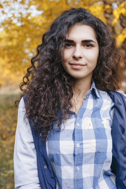 Portrait of pretty young woman with long curly hair - Photo, image