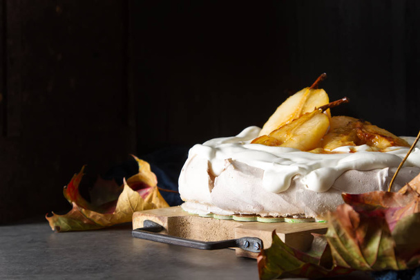 A traditional Pavlov dessert with pears and white cream. French  - Foto, Imagem