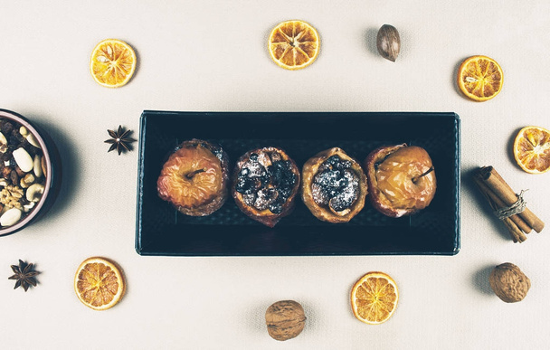 Baked apples stuffed with dried fruit nuts.  - 写真・画像