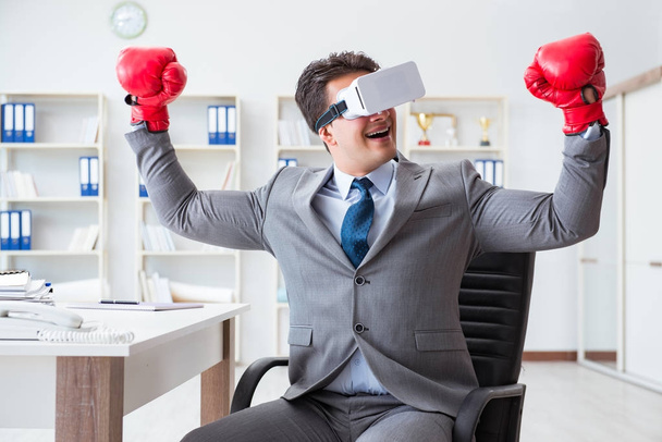 Man boxing in the office with virtual reality goggles - Photo, Image
