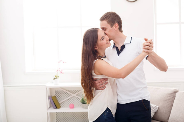 Young couple dancing at home, copy space - Foto, Imagen