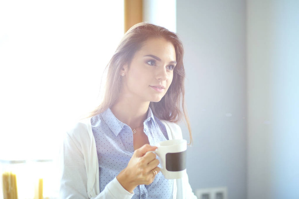 happy woman drinking tea in the kitchen at home. Woman at home - Foto, Imagen