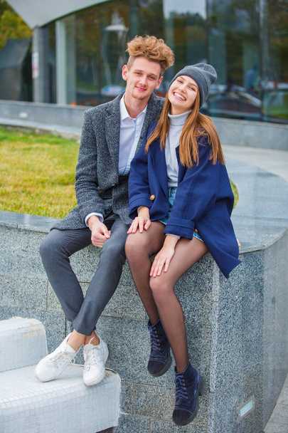 Cheerful young couple having fun and laughing together outdoors. - Фото, зображення