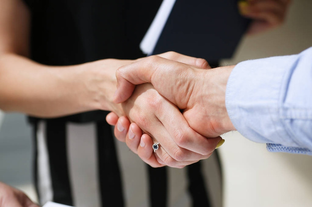 Businessman and woman shake hands as hello - Photo, Image