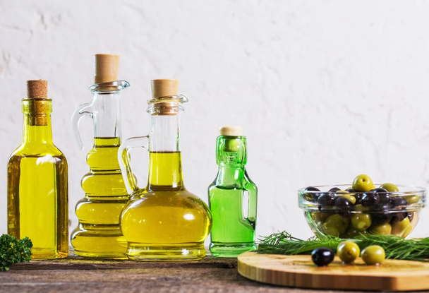Olive oil  on the wooden table - Фото, изображение