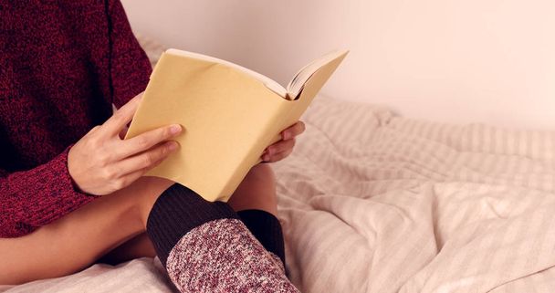 Woman reading book on bed  - Photo, Image