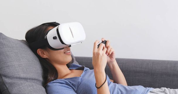 Жінка грає в гру з VR
  - Фото, зображення