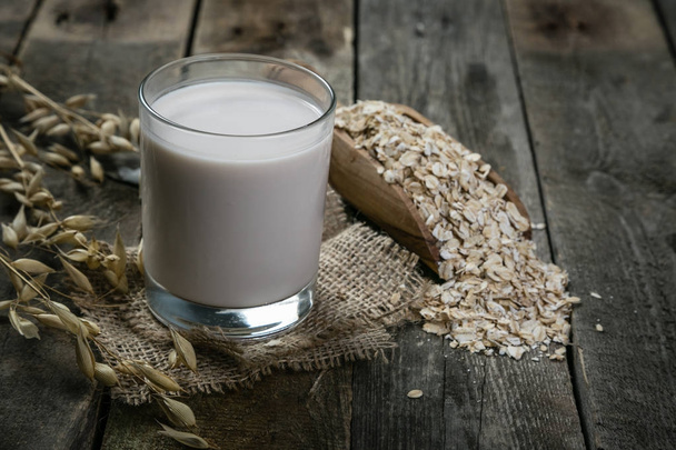 Oat milk alternative on rustic wood background - Foto, imagen