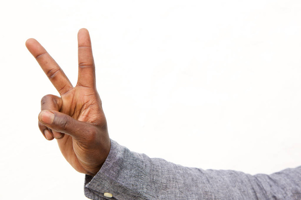 mies käsi osoittaa rauhan merkki
  - Valokuva, kuva