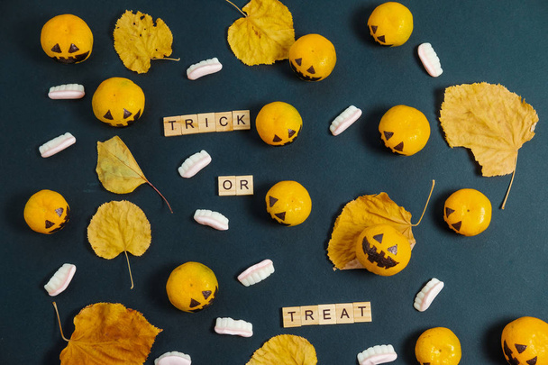 Flat Lay Trick or Treat  Halloween with fake pumpkins and tanger - Fotó, kép