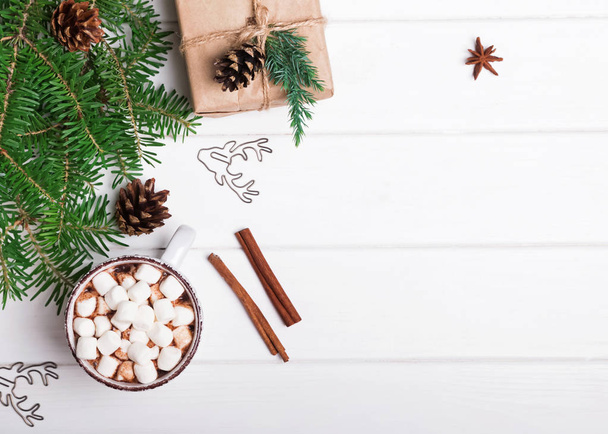 Hot chocolate, fir branches and Christmas gift on white backgrou - Φωτογραφία, εικόνα