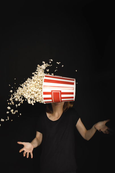 woman with flying bucket of popcorn - Foto, Bild