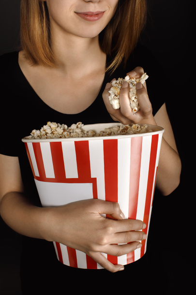 woman with bucket of popcorn - Фото, зображення