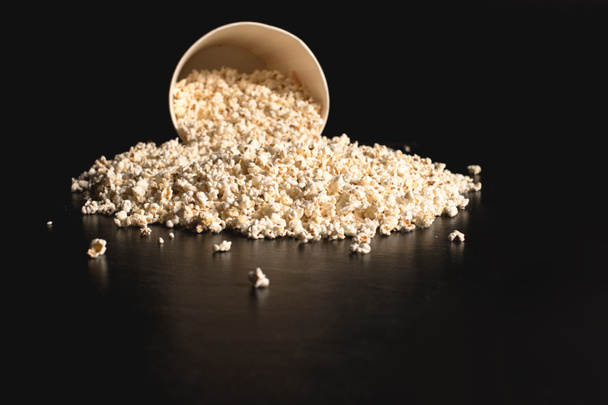 popcorn spilled from cardboard bucket - Photo, Image