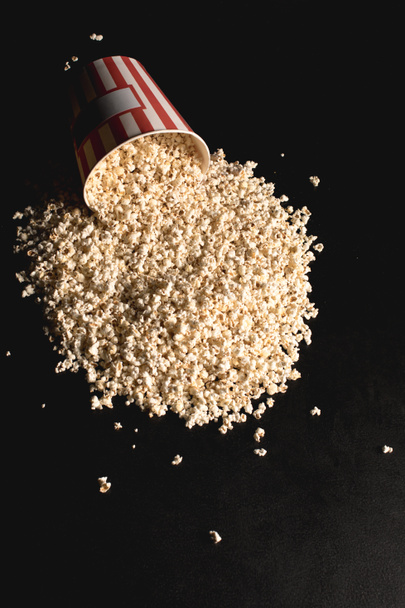 popcorn spilled from cardboard bucket - Photo, Image
