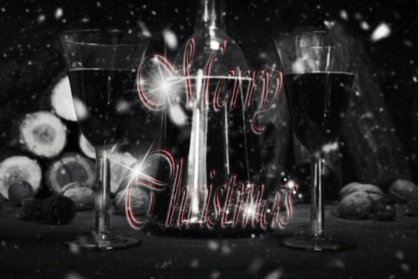 Merry Christmas Sign With Red Wine Vintage Bottle and Glasses Resting On Wooden Table With Stardust and Snowflakes in The Background - 写真・画像