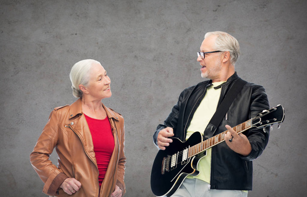 happy senior couple with electric guitar - Фото, зображення