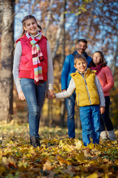 Happy family walking in autumn park - Fotoğraf, Görsel