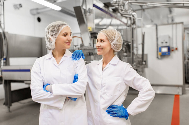 happy women technologists at ice cream factory - Valokuva, kuva