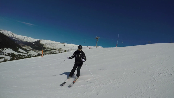 Sciatore in montagna in inverno rotola giù per un veloce sentiero in discesa tortuoso
. - Filmati, video