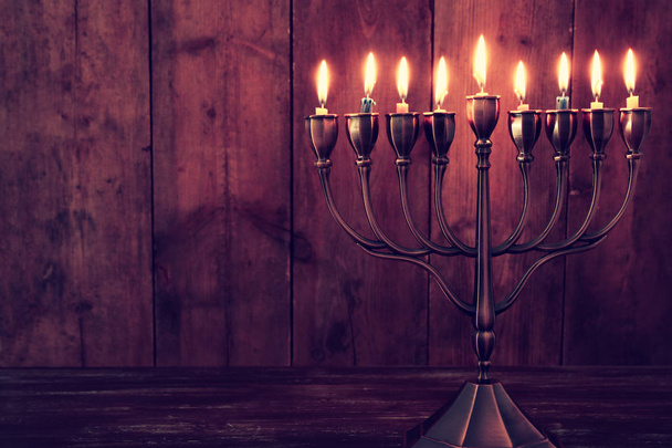jewish holiday Hanukkah background with menorah (traditional candelabra) and burning candles - 写真・画像