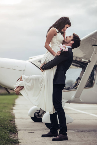 Couple near plane - Фото, изображение