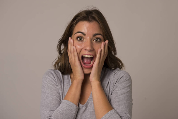 young attractive and beautiful woman screaming excited and happy in nice shock and surprise showing positive and fun - Фото, изображение