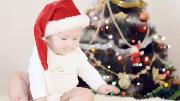 Baby in Christmas hat on the new year background - 映像、動画