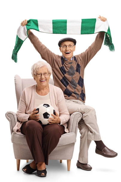 Overjoyed soccer fans sitting in an armchair - Photo, image