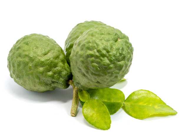 close up group of fresh bergamot with green leaves isolated on white background. benefits of bergamot for beauty and health concept - Photo, Image