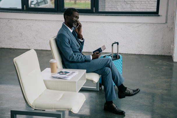 Businessman talking by smartphone in airport - Photo, Image