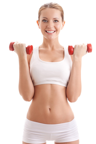 Beautiful woman holding two dumbbells - 写真・画像