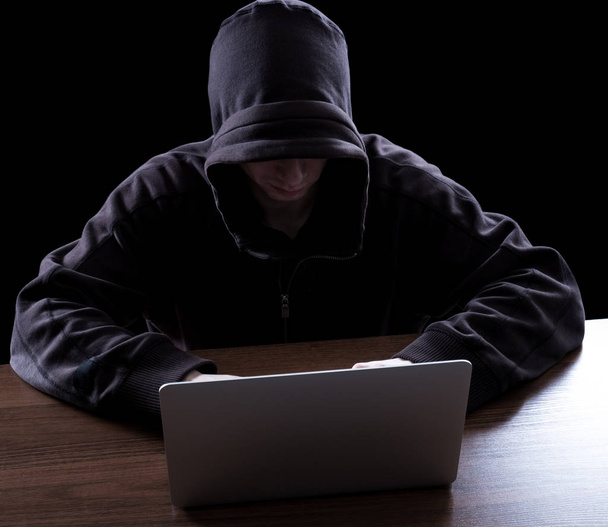 Anonymous hacker in the dark - Фото, зображення