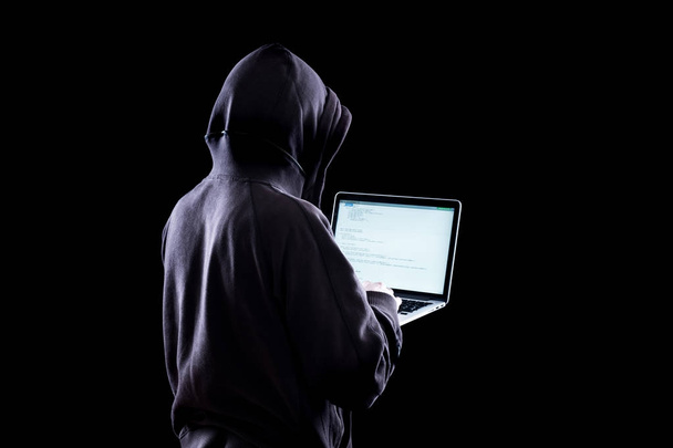 Anonymous hacker in the dark - Фото, изображение
