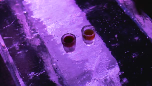 Hands taking cold glasses with beverage and drinking to bottom, original ice bar - Filmagem, Vídeo