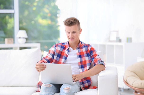 Young man with laptop  - Foto, Bild
